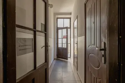 an empty hallway with a door and a hallway sidx sidx at 1-Bedroom Apartment - Długa 65 in Kraków