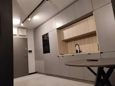 a kitchen with a sink and a table in it at Wałowa Stylowe studio, AWG APARTMENTS in Kraków