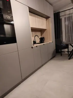 a kitchen with white cabinets and a table in a room at Wałowa Stylowe studio, AWG APARTMENTS in Kraków