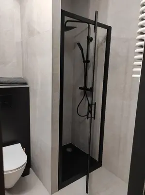 a shower in a bathroom with a toilet at Wałowa Stylowe studio, AWG APARTMENTS in Kraków