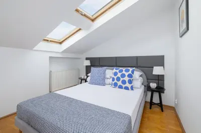 a bedroom with a large bed with blue and white pillows at Old Town - Apartment with AC - Długa 65 in Kraków