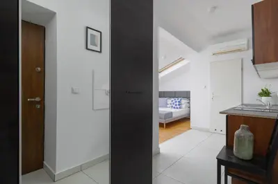 a kitchen and living room with a black door at Old Town - Apartment with AC - Długa 65 in Kraków