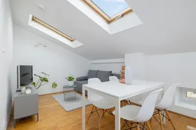 a white living room with a white table and chairs at Old Town - Apartment with AC - Długa 65 in Kraków