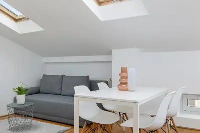 a living room with a couch and a table and chairs at Old Town - Apartment with AC - Długa 65 in Kraków