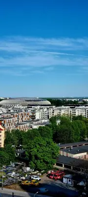 a city with buildings and a parking lot with cars at Movie Nights Tauron Arena in Kraków