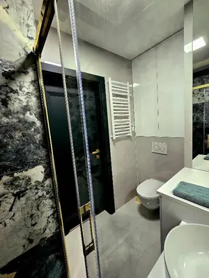 a bathroom with a shower and a sink and a toilet at Movie Nights Tauron Arena in Kraków