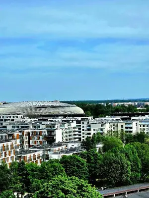a large building with a roof on top of it at Movie Nights Tauron Arena in Kraków