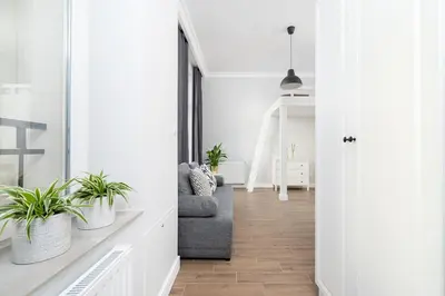 a living room with a couch and potted plants at Kazimierz District - Starowislna 43 in Kraków