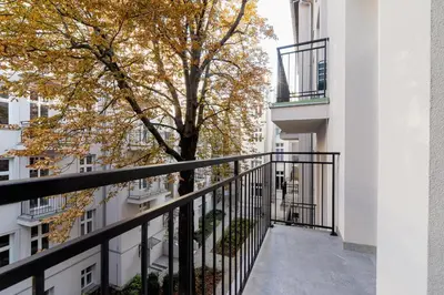 a balcony of a building with a tree at Kazimierz District - Starowislna 43 in Kraków