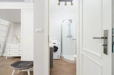 a bathroom with a shower and a washing machine at Kazimierz District - Starowislna 43 in Kraków