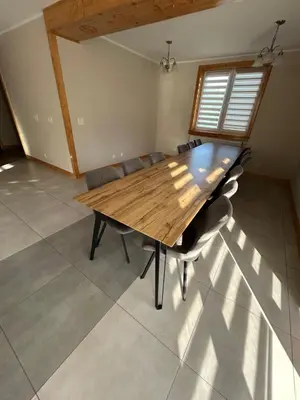 a dining room with a wooden table and chairs at Dom wypoczynkowy z widokiem na LUBAŃ in Ochotnica Dolna