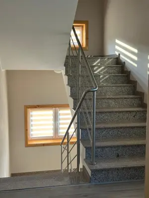 a staircase in a house with a window at Dom wypoczynkowy z widokiem na LUBAŃ in Ochotnica Dolna