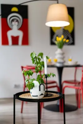 a living room with a table with a plant on it at ICE Art by Cozyplace in Kraków
