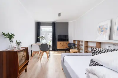 a bedroom with a bed and a table and chairs at One bedroom apartment Kalwaryjska 34 street in Kraków