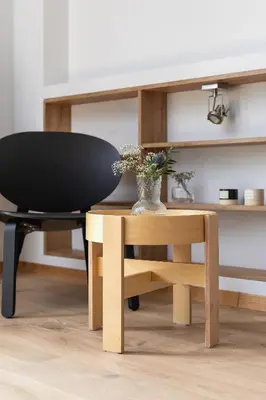 a black chair and a desk with a vase on it at One bedroom apartment Kalwaryjska 34 street in Kraków