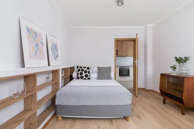 a bedroom with a bed and a dresser at One bedroom apartment Kalwaryjska 34 street in Kraków