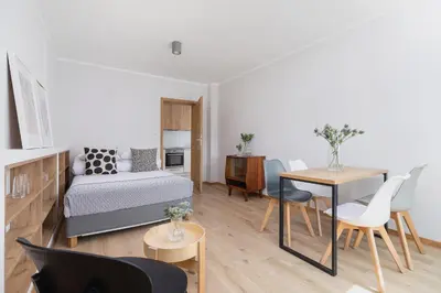 a living room with a bed and a table at One bedroom apartment Kalwaryjska 34 street in Kraków