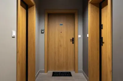 a row of wooden doors in a hallway at Kalwaryjska 34 street Studio with balcony in Kraków
