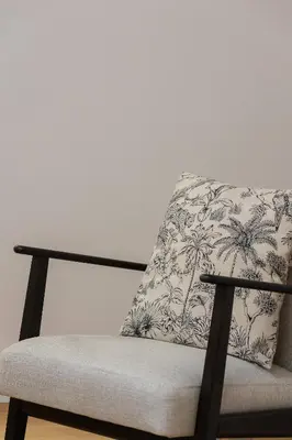 a chair with a pillow on top of it at Kalwaryjska 34 street Studio with balcony in Kraków