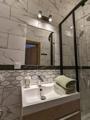 a bathroom with a sink and a mirror at Apartment A4 In Downtown Of Krakow in Kraków