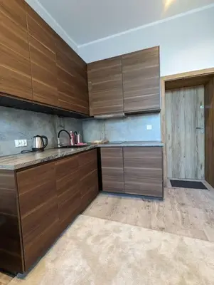 a kitchen with wooden cabinets and a sink in it at Apartment A4 In Downtown Of Krakow in Kraków