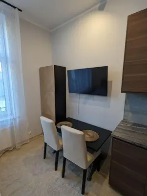a room with a table and two chairs and a television at Apartment A4 In Downtown Of Krakow in Kraków