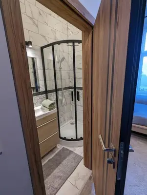 a bathroom with a shower and a glass door at Apartment A4 In Downtown Of Krakow in Kraków