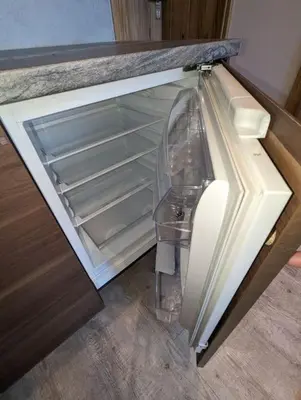 an empty refrigerator with its door open in a kitchen at Apartment A4 In Downtown Of Krakow in Kraków