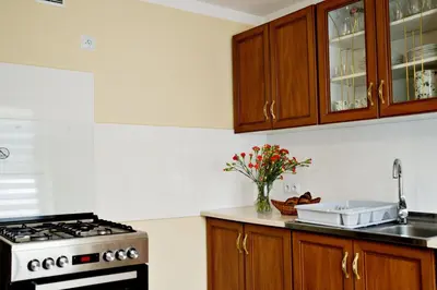 a kitchen with a vase of flowers and a basket of bread at Magic Apartments - Garden in Zator