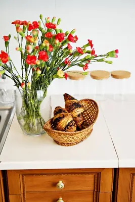 a kitchen with a stove and a vase of flowers at Magic Apartments - Garden in Zator
