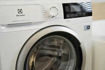 a bathroom with a washing machine and a sink at Magic Apartments - Garden in Zator
