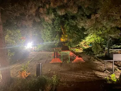 a garden at night with a light in the background at Grojecka Ostoja in Grojec