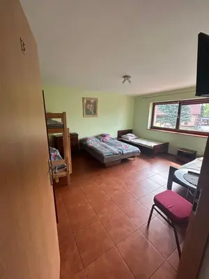 a living room with a couch and a table at Grojecka Ostoja in Grojec