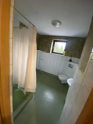 a bathroom with a shower and a toilet and a window at Grojecka Ostoja in Grojec