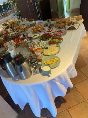 a table with a buffet of food on it at Grojecka Ostoja in Grojec