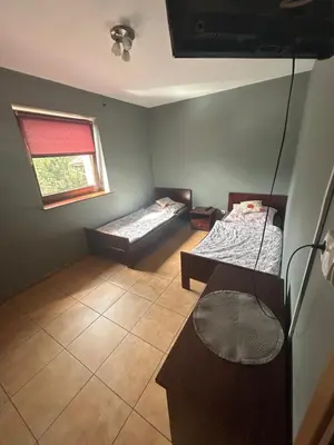 a room with two beds and a window at Grojecka Ostoja in Grojec