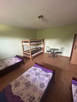 a room with two bunk beds and a table at Grojecka Ostoja in Grojec