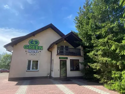 a green hotel sign on the side of a building at Hotel GoGreen *** in Kraków
