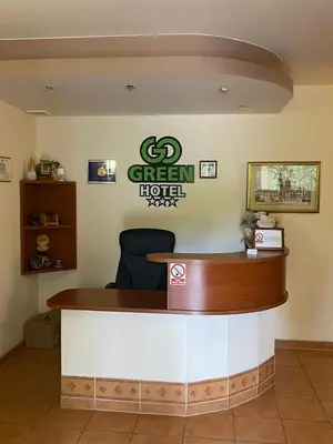 a reception desk in a green hotel lobby at Hotel GoGreen *** in Kraków