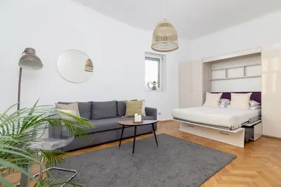 a living room with a couch and a table at Apartment with balcony - Paulinska 8 street in Kraków