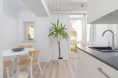 a kitchen with a table and a potted plant at Apartment with balcony - Paulinska 8 street in Kraków