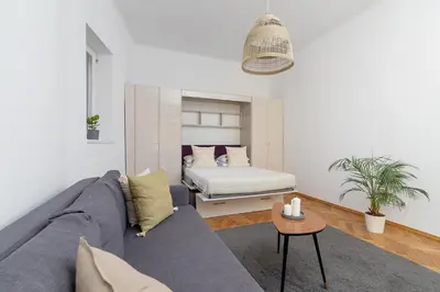 a living room with a couch and a bed at Apartment with balcony - Paulinska 8 street in Kraków
