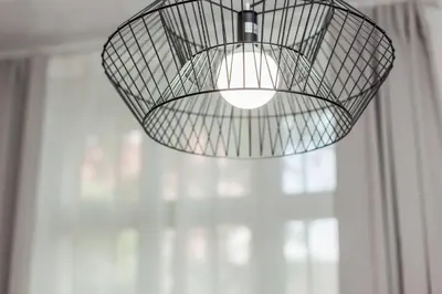 a light fixture hanging from a ceiling at Kazimierz District - Paulińska 18 Street in Kraków