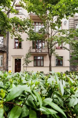 a building with a tree in front of it at Kazimierz District - Paulińska 18 Street in Kraków