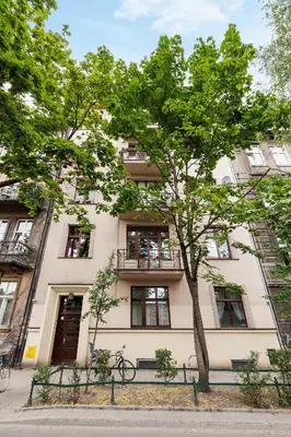 a building with a tree in front of it at Kazimierz District - Paulińska 18 Street in Kraków