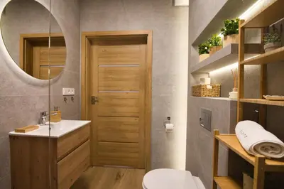 a bathroom with a toilet and a sink and a mirror at Jaśminowa Ostoja Zator by Housine in Zator