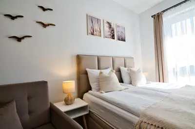 a bedroom with a large bed and a window at Jaśminowa Ostoja Zator by Housine in Zator