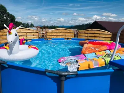 a pool with an inflatable unicorn in the water at Domek na Wierchu Bukowiny in Załuczne