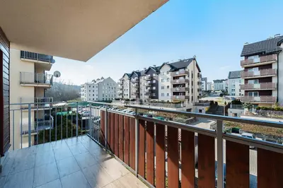 an apartment balcony with a view of a city at Apartament Chrobrego Wieliczka 2 in Wieliczka