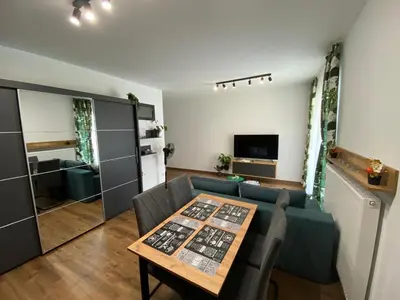 a living room with a table and a couch at EM Room in Kraków